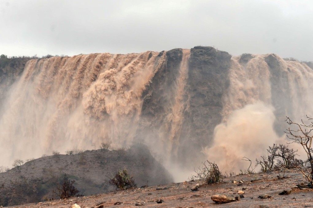 Rushing waters from the rain and storm surges flooded typically dry creek beds in Salalah, Oman. Photo: Reuters