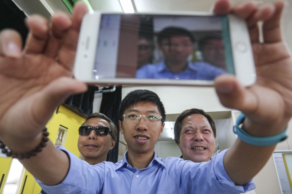 Lo Hoi (left), Michael Fung and Tang Kwong-po, chairman of the Hong Kong Federation of the Blind, which helped test the app. Photo: Jonathan Wong