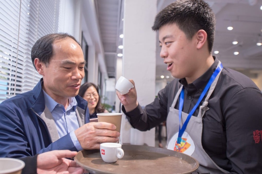 Trained customers chat with the young baristas so they can get better at interacting with others. Photo: Alice Yan