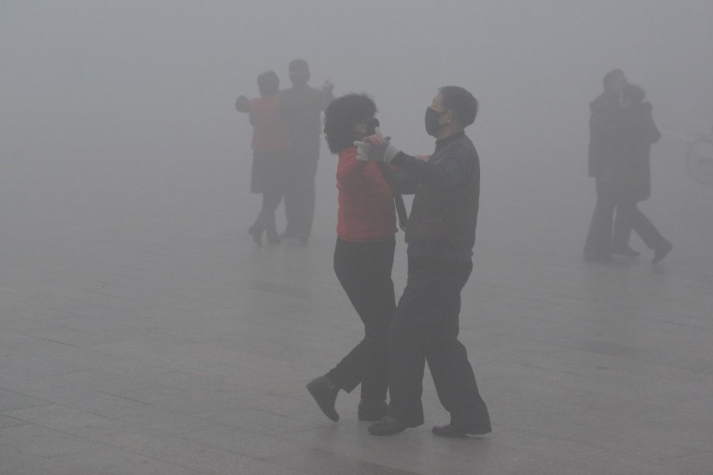 People wearing face masks dance in a square on a polluted day in the eastern China city of Fuyang. Photo: Reuters