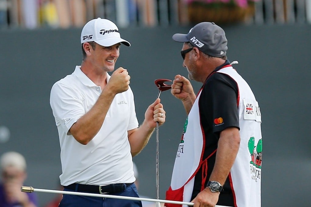Justin Rose of England celebrates with caddie Mark Fulcher on the 18th green after winning the Fort Worth Invitational. Photo: AFP