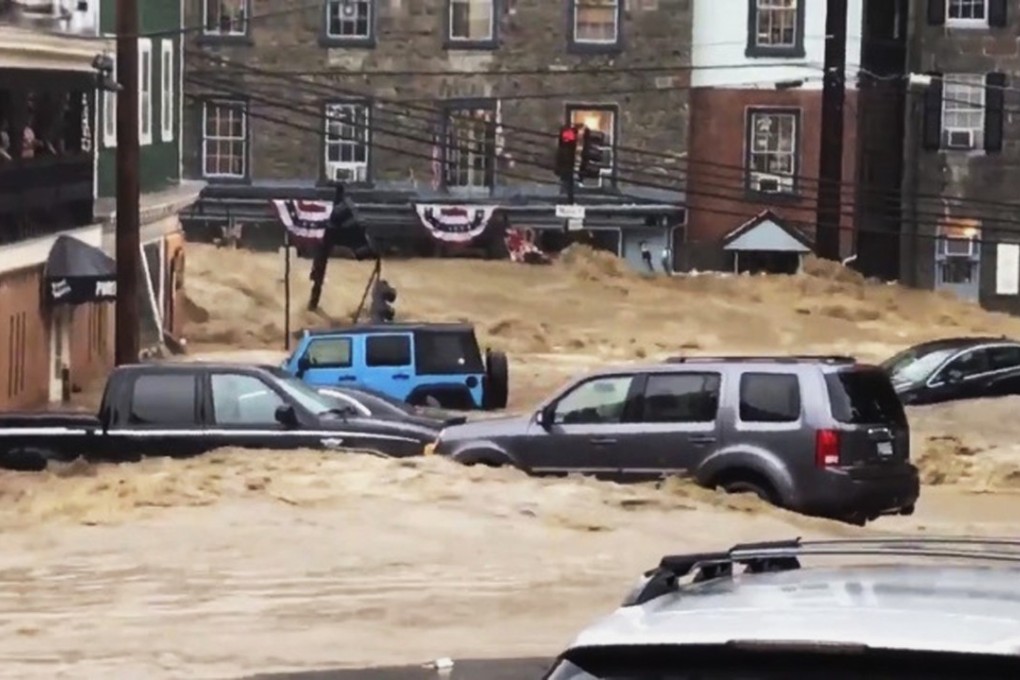 Floodwater rushes through Main Street in Ellicott City, Maryland, on Sunday, sweeping vehicles away. Photo: AP
