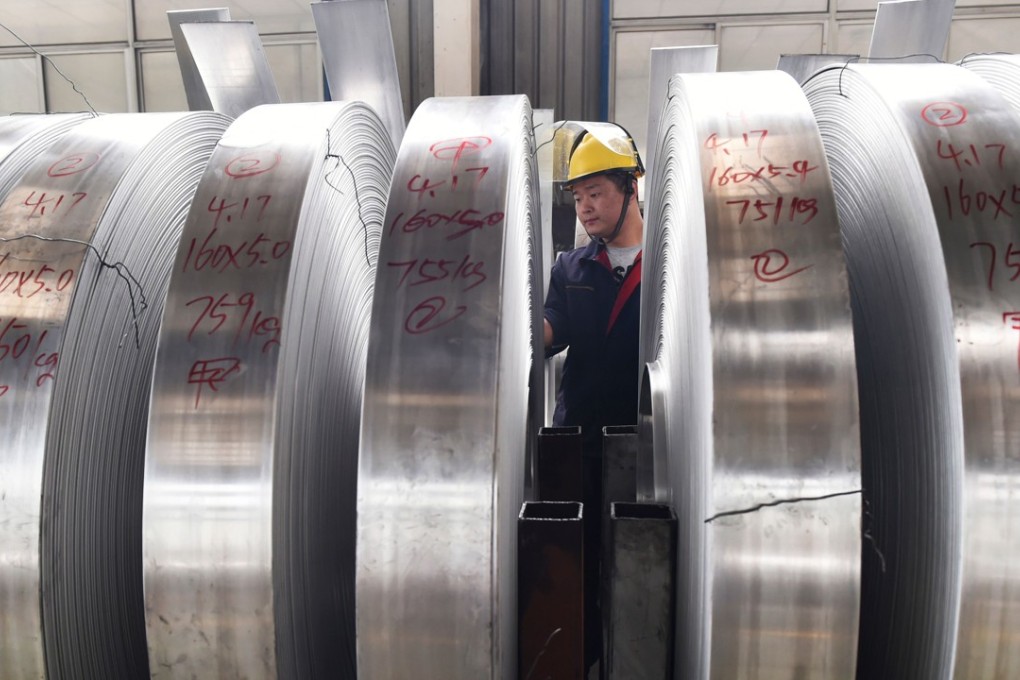 A worker checks rolls of aluminium at a factory in China's eastern Shandong province. Photo: AFP