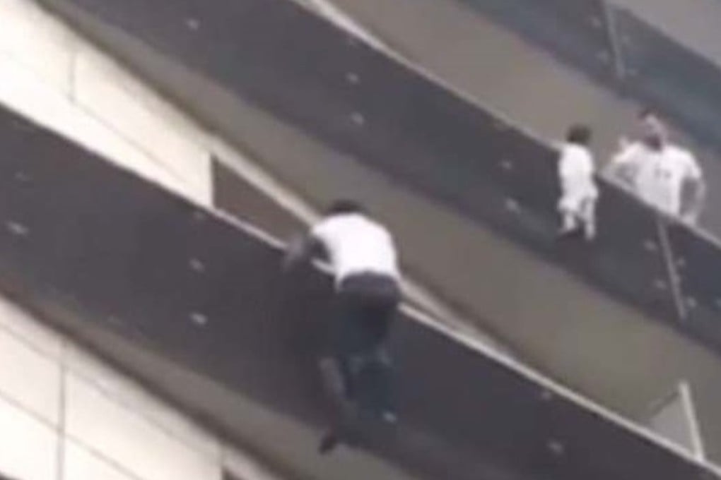 Mamoudou Gassama scrambles up the side of a building in Paris to save a boy dangling from a fourth-storey ledge. Photo: Habib Bibou / Facebook