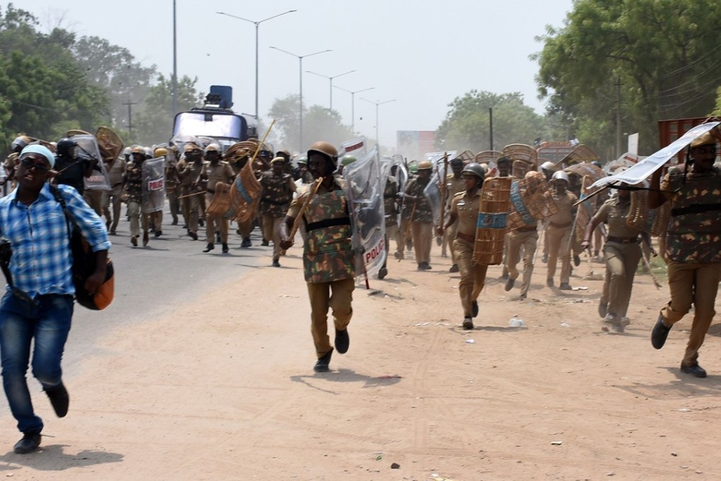 Indian police charge towards protestors on May 22 in the southern Indian city of Tuticorin during a protest to demand the closure of a copper factory due to pollution concerns. Photo: AFP