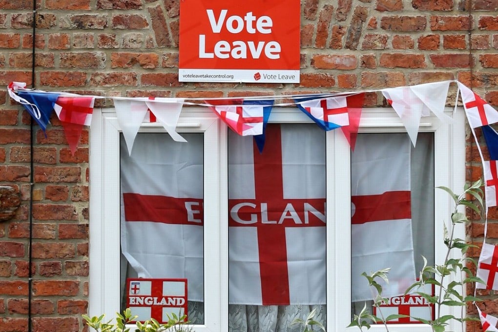 English Cross of St George flags hang in a windows with a Vote Leave poster in Redcar, northeast England on June 27, 2016. Photo: Agence France-Presse