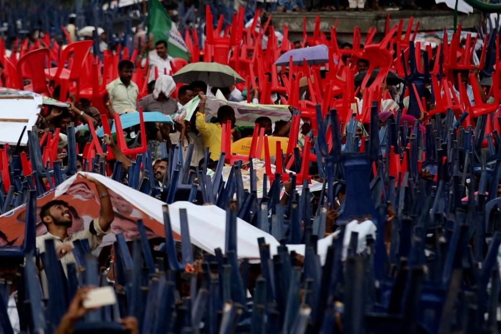 Supporters use chairs to shelter from heavy rain during the swearing-in ceremony of H. D. Kumaraswamy as chief minister in the state of Karnataka, Bangalore, on May 23. Kumaraswamy will lead a coalition government of the opposition Congress party and Janata Dal (Secular), a regional ally. He replaces B. S. Yeddyurappa of the Bharatiya Janata Party, who was in office for less than three days. Photo: EPA-EFE
