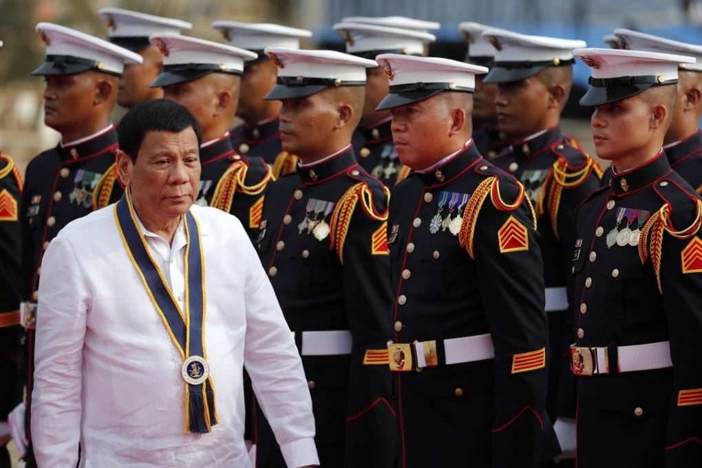 Filipino President Rodrigo Duterte reviews honour guards during the 120th Philippine navy anniversary celebration in Manila, Philippines, on Wednesday. Photo: EPA-EFE