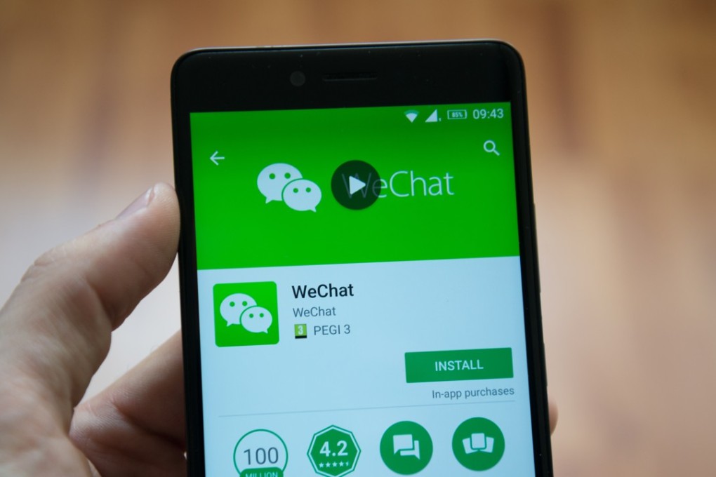 Man holding a phone with WeChat application. Photo: Shutterstock