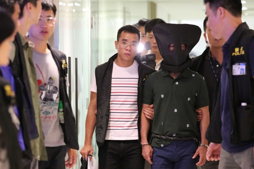 Investigators escorted the suspect back to the jewellery shop to reconstruct the crime. Photo: Felix Wong
