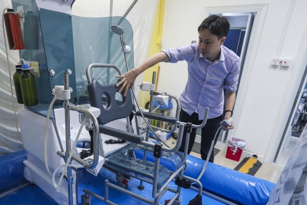 Inventor Samuel Hui Sing-kwong with his automated bathing device in Kwai Chung. Photo: Jonathan Wong