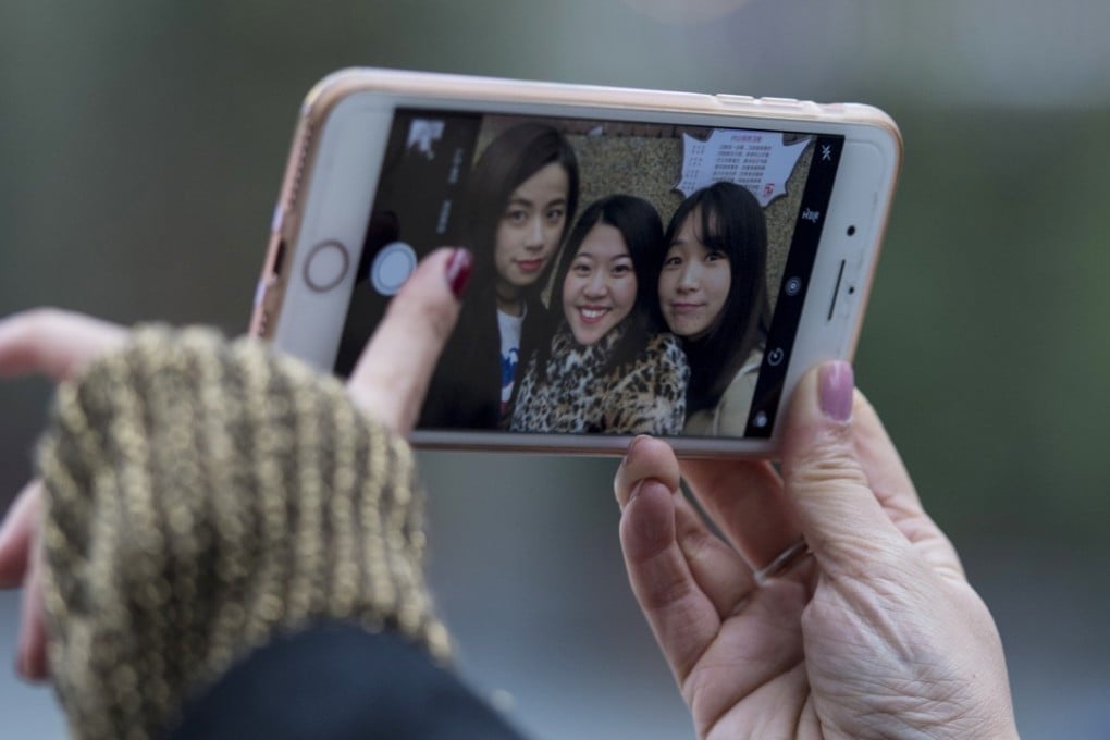 Women posing for a selfie in the streets of Shanghai. Photo: AFP