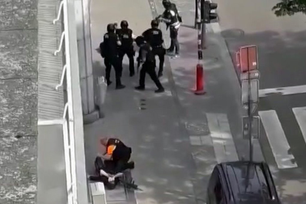 In this frame grab taken from video, police apprehend a man believed to be the attacker, near an unidentified injured person thought to be a police officer after Tuesday’s attack in Liege, Belgium. Photo: AP