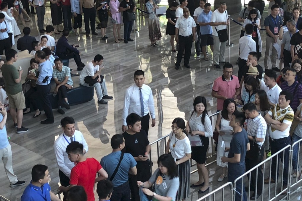 About 881 people turned up on Wednesday in the hope of getting a chance to buy one of the 167 units on sale at Shenzhen China Merchants Real Estate’s Shuangxi Garden project in Shenzhen. Photo: Pearl Liu