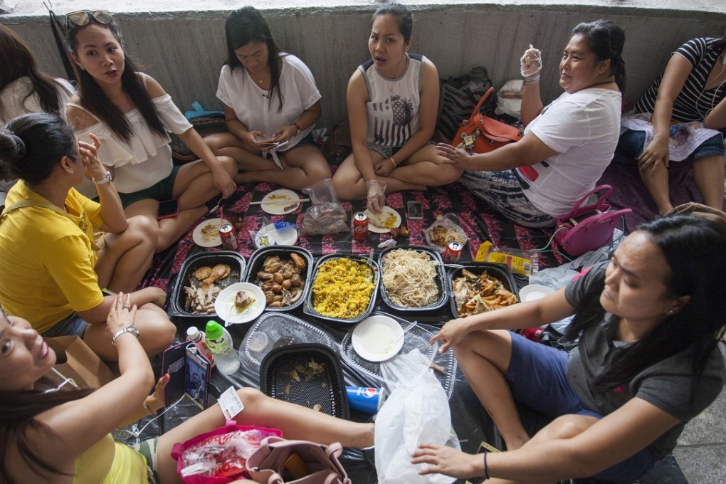 Foreign domestic helpers from the Philippines and Indonesia gather in a public place on Sunday. On their days off, Hong Kong’s 380,000 domestic helpers need a place to relax with friends. Photo: EPA-EFE