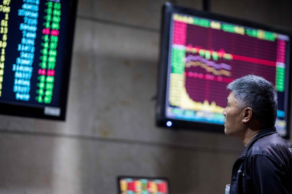 An investor monitors stock prices at a securities company in Shanghai on Thursday. Chinese stocks gained ahead of their inclusion in MSCI benchmarks on June 1. Photo: AFP