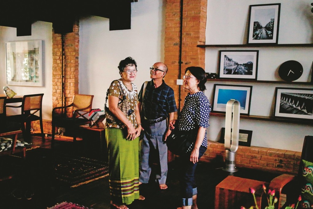 Thein Aung (centre) and his family travelled back to Myanmar from the United States to see the renovated family house. Photo: Ann Wang