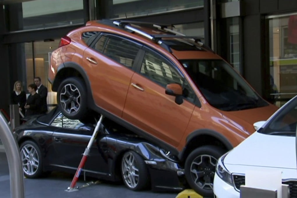 The Porsche Carrera underneath the other vehicle. Photo: AP