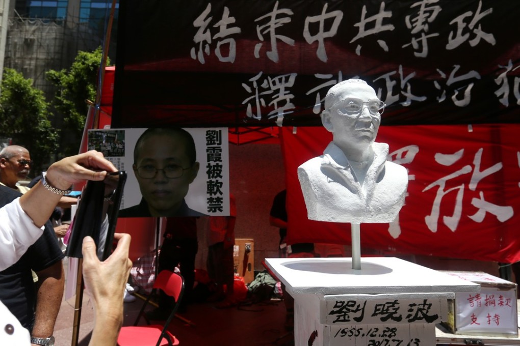 The bust of Liu Xiaobo is unveiled in Causeway Bay as pan-democrats collect signatures to call for the release of his wife. Photo: Xiaomei Chen