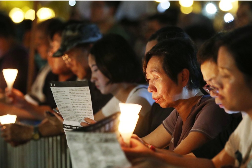 Mourners hold candles during Hong Kong’s annual June 4 vigil in Victoria Park. Photo: Edward Wong