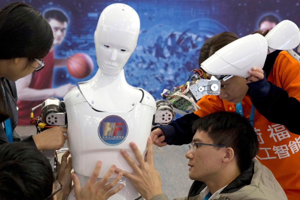 Chinese students work on a robot they designed, at the World Robot Conference in Beijing, in October 2016. China’s “Made in China 2025” plan calls for the country to develop its own global competitors in fields from information technology and electric cars to pharmaceuticals. Photo: AP