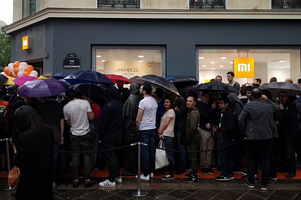 Customers wait outside a newly opened Xiaomi Store in Paris. The smartphone maker’s US$10 billion IPO is expected in July. Photo: Xinhua