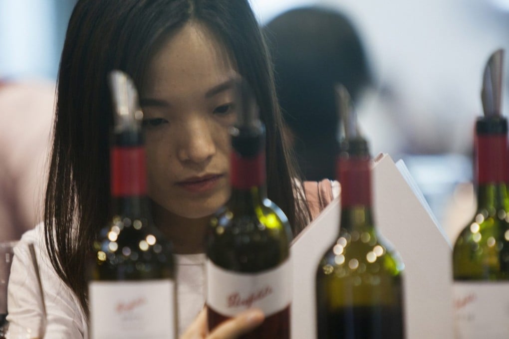 A Chinese buyer of fine wine attends the Vinexpo Hong Kong trade fair this week. China’s preference for red wine will change, says British expert Robert Joseph. Photo: EPA