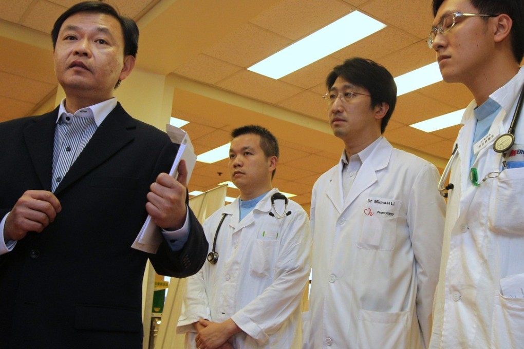 The Hospital Authority chief executive, Dr Leung Pak-yin (left), speaks to reporters after meeting doctors at Tuen Mun Hospital to discuss staff shortage and heavy workloads, in 2011. Photo: Dickson Lee