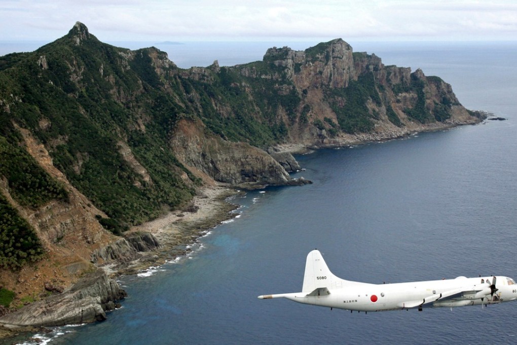 A Japanese surveillance plane flies over disputed islands in the East China Sea, called the Senkaku in Japan and Diaoyu in China. Photo: AP