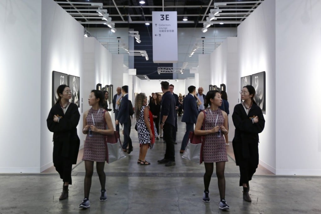 A mirror doubles artwork and visitors at the Hong Kong Art Basel, at the Convention and Exhibition Centre in Wan Chai in March. Photo: Xiaomei Chen