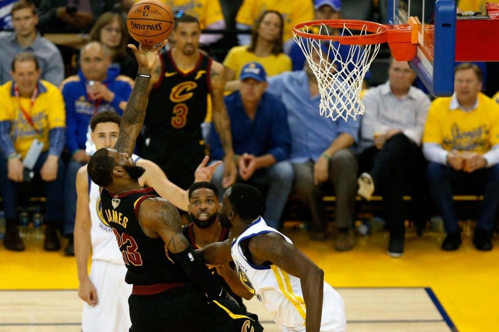 LeBron James of the Cleveland Cavaliers attempts a lay-up against Draymond Green of the Golden State Warriors in game one of the 2018 NBA Finals. Photo: AFP