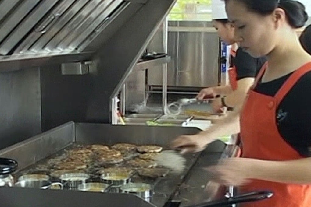 Flipping burgers at a Samtaesong in Pyongyang. Photo: AP