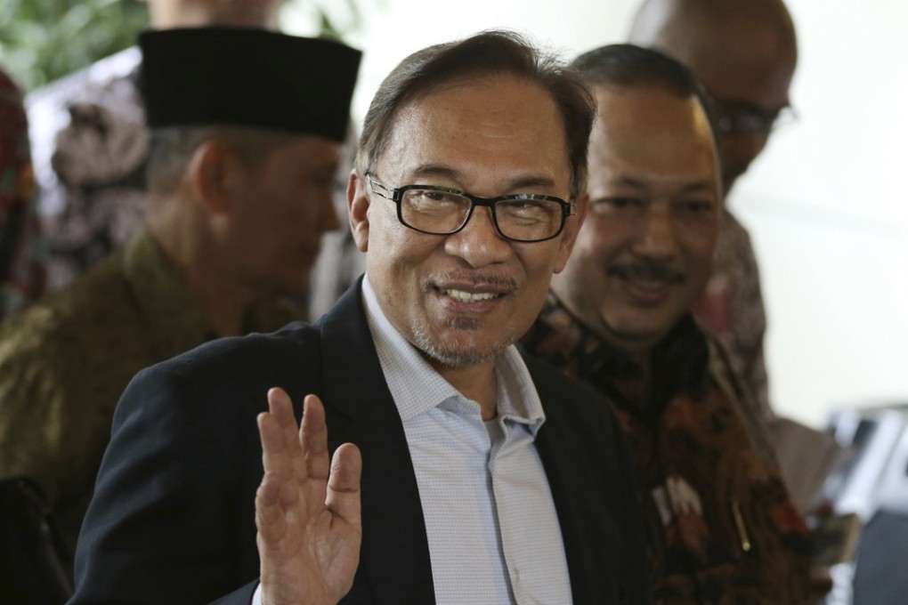 Anwar Ibrahim waves at reporters in Jakarta, Indonesia on May 20. Photo: AP
