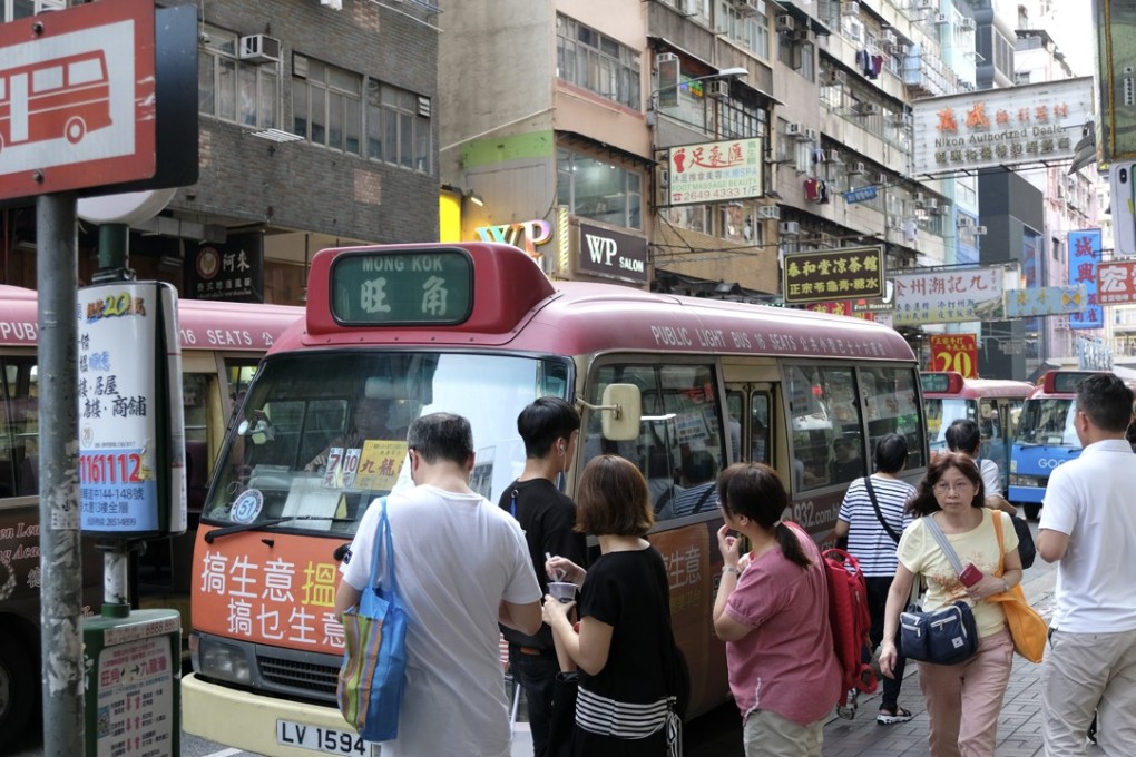 Commuters have no protection from the elements as they wait at this minibus stop in Mong Kok. Photo: Fung Chang