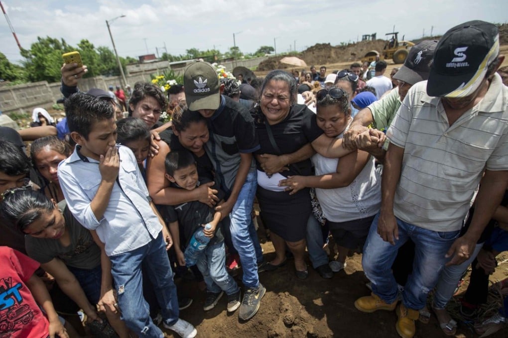 Yadira Cordoba (centre) cries at the burial of her son Orlando Cordoba who was killed on May 30 during a protest called ‘the mother of all the marches’. Photo: EPA