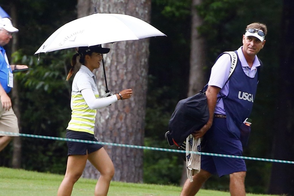 Tiffany Chan walks back to the clubhouse while play is suspended because of lightning in the area during the second round of the US Women’s Open golf tournament at Shoal Creek in Birmingham, Alabama. Photo: AP