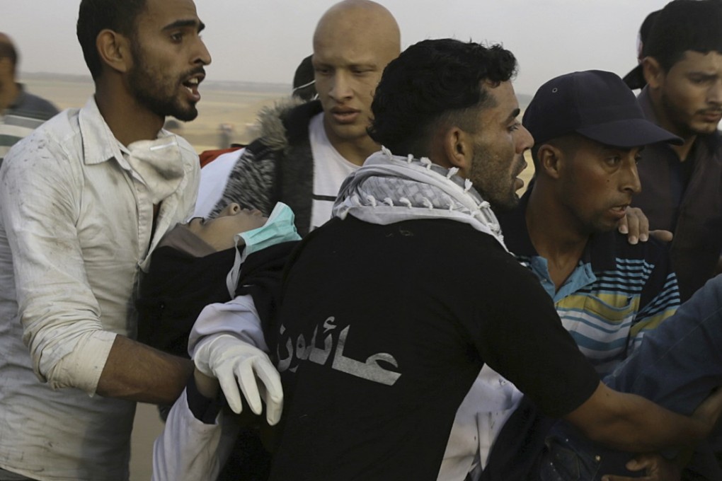 Palestinian protesters evacuate female medic of Razan Najjar after she was shot in the chest. Photo: AP