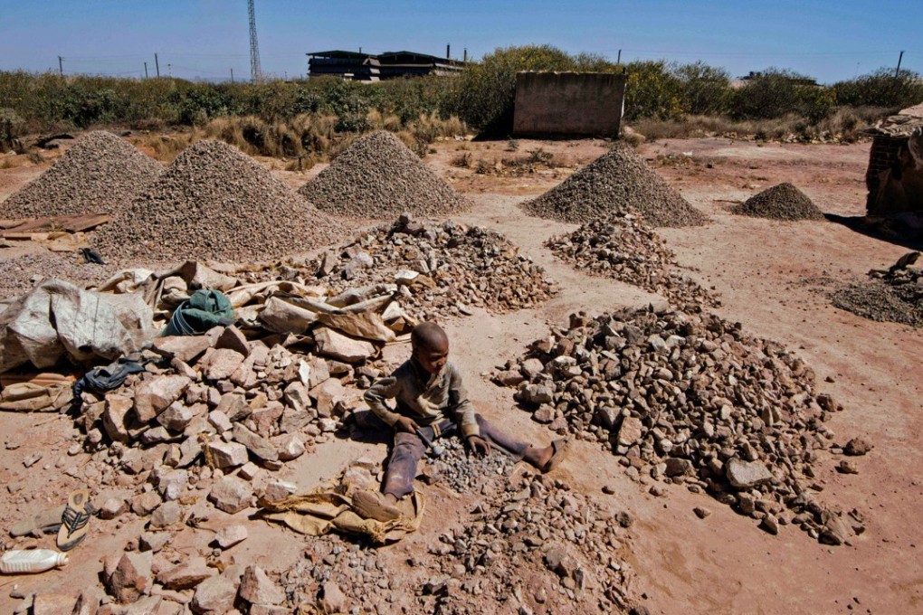 A child breaks rocks extracted from a cobalt pit in Lubumbashi in the Democratic Republic of Congo. Prices of the metal have jumped in the past two years amid uncertain supplies and stockpiling activities. Photo: AFP