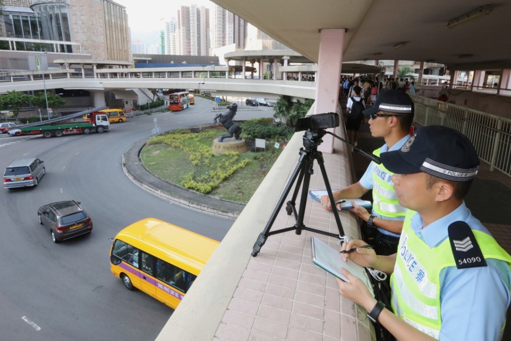 Police officers demonstrate the use of handheld video cameras to combat offences related to inattentive driving, in Tai Wai on May 2. Photo: Felix Wong