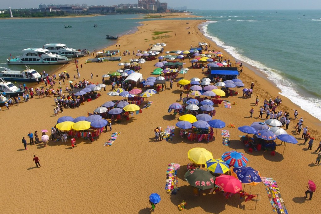 Tourists catch some rays on Yudai Beach in Boao in Hainan. Photo: Xinhua