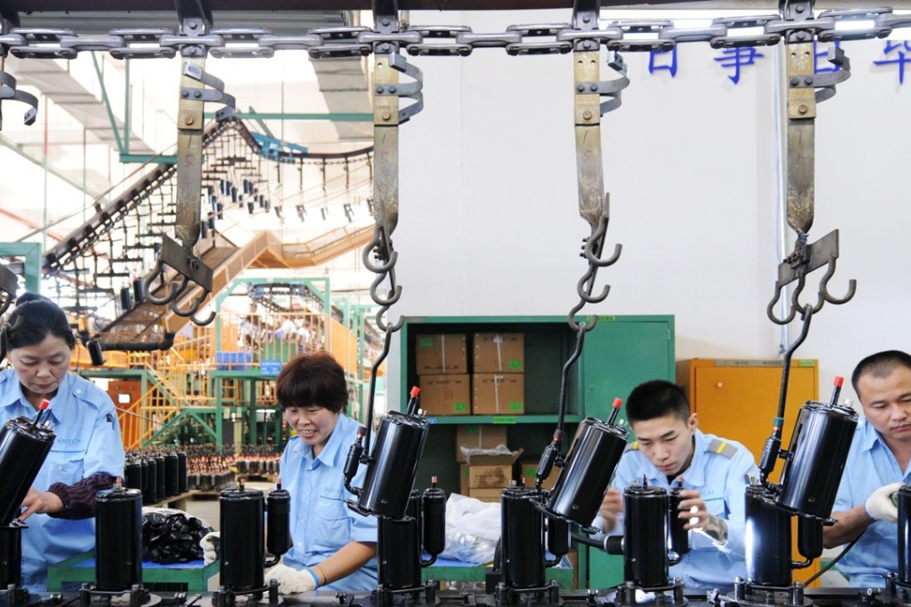 Employees on the production line for domestic appliances at a factory in Jiujiang in Jiangxi province on April 19, 2018. Photo: AFP