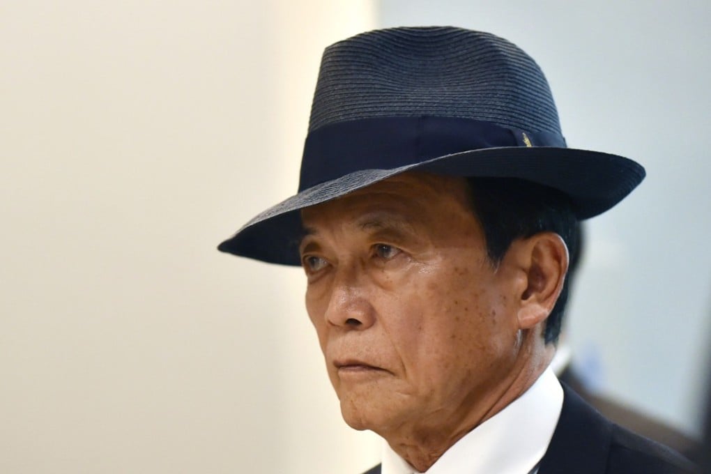 Japan’s Finance Minister Taro Aso has taken a voluntary one-year salary cut after 20 officials were penalised for tampering with documents. File photo: AFP