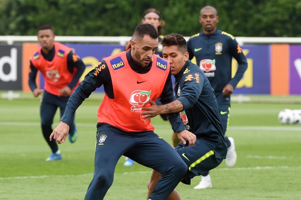 Brazil’s Roberto Firmino (right) and Renato Augusto (left) in action during a training session. Photo: EPA