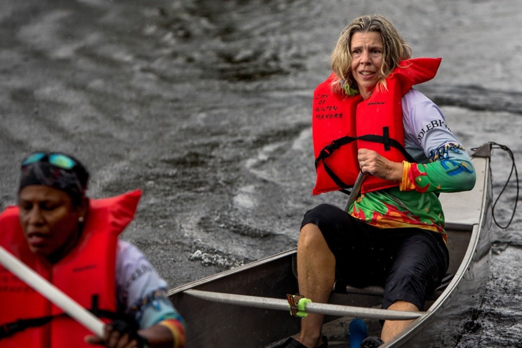 Judy Perkins, right, paddles during a team canoe race in Wilton Manors, Florida. Perkins has undergone an experimental breast cancer treatment and has seen “remarkable” results. Photo: The Washington Post