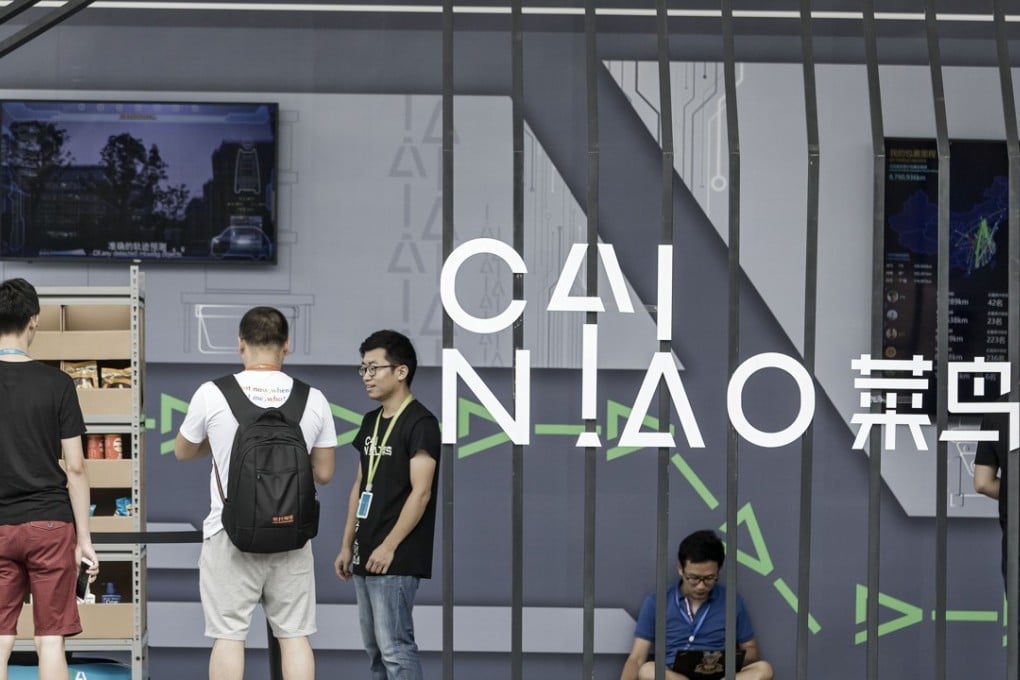 Employees and visitors stand at the Cainiao display at the Alibaba Group headquarters in Hangzhou, China. Photo: Bloomberg