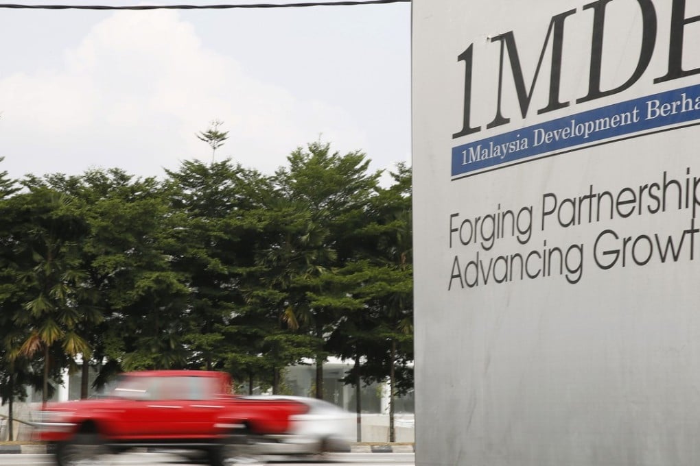 Traffic passes a 1Malaysia Development Berhad (1MDB) billboard at the Tun Razak Exchange development in Kuala Lumpur. Malaysia’s newly appointed attorney general Tommy Thomas said on Wednesday there would be “no cover ups”. Photo: Reuters
