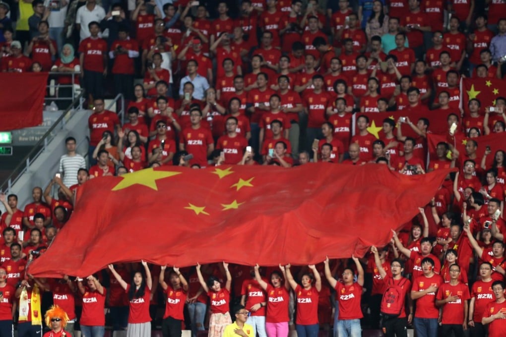 Chinese fans hold their national flag before the start of the Fifa World Cup 2018 qualification match against Qatar in Doha. Photo: AFP