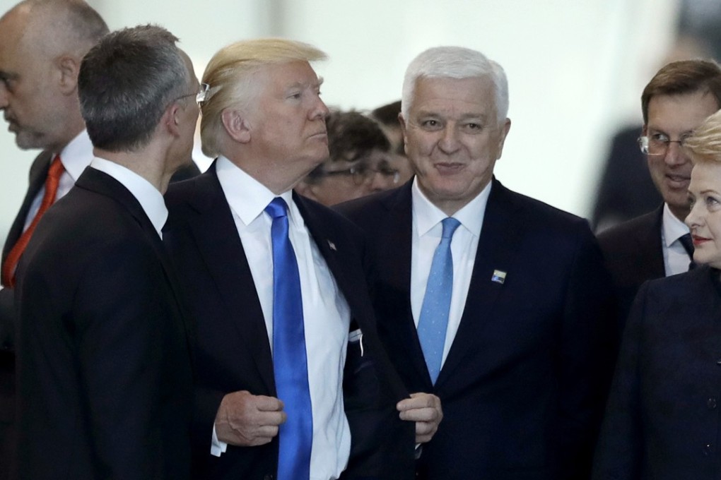 US President Donald Trump acts as if nothing has happened after appearing to shove Montenegrin Prime Minister Dusko Markovic (centre) out of the way so he could assume a more prominent place in a group photo of leaders attending a Nato summit in Brussels – not his only awkward moment in front of the cameras. Photo: AP