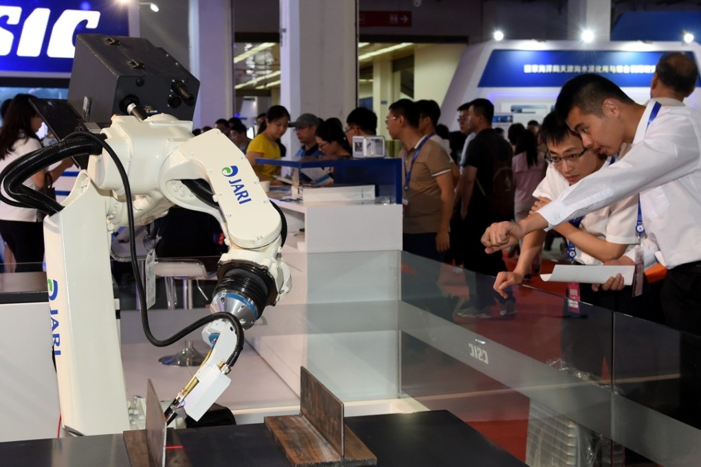 Robots are put through their paces at the China Beijing International High-tech Expo in Beijing in May. Photo: Xinhua