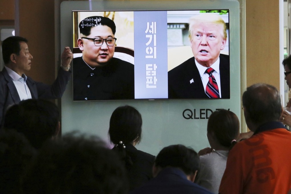 People in a South Korean railway station watch a television report about the planned forthcoming meeting between Kim Jong-un and Donald Trump, accompanied by the caption “negotiations of the century”. Photo: AP